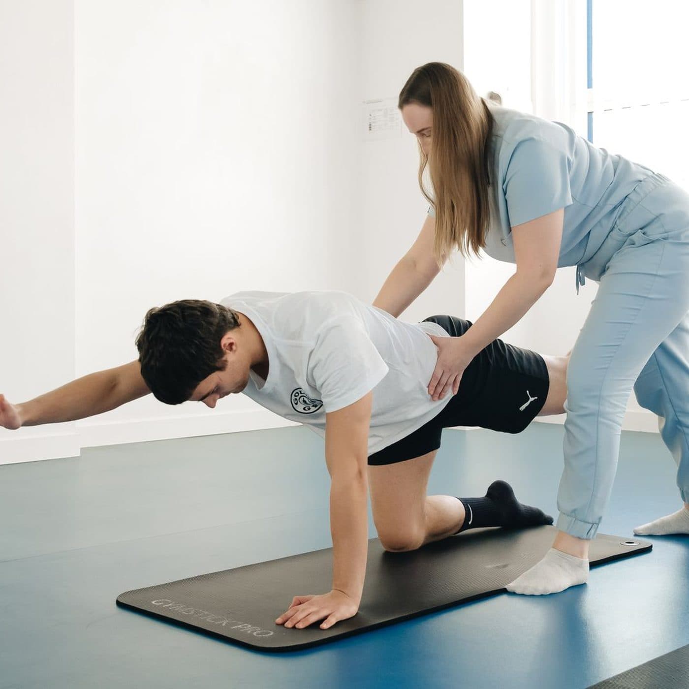 Physiotherapist guiding a patient through a rehabilitation exercise