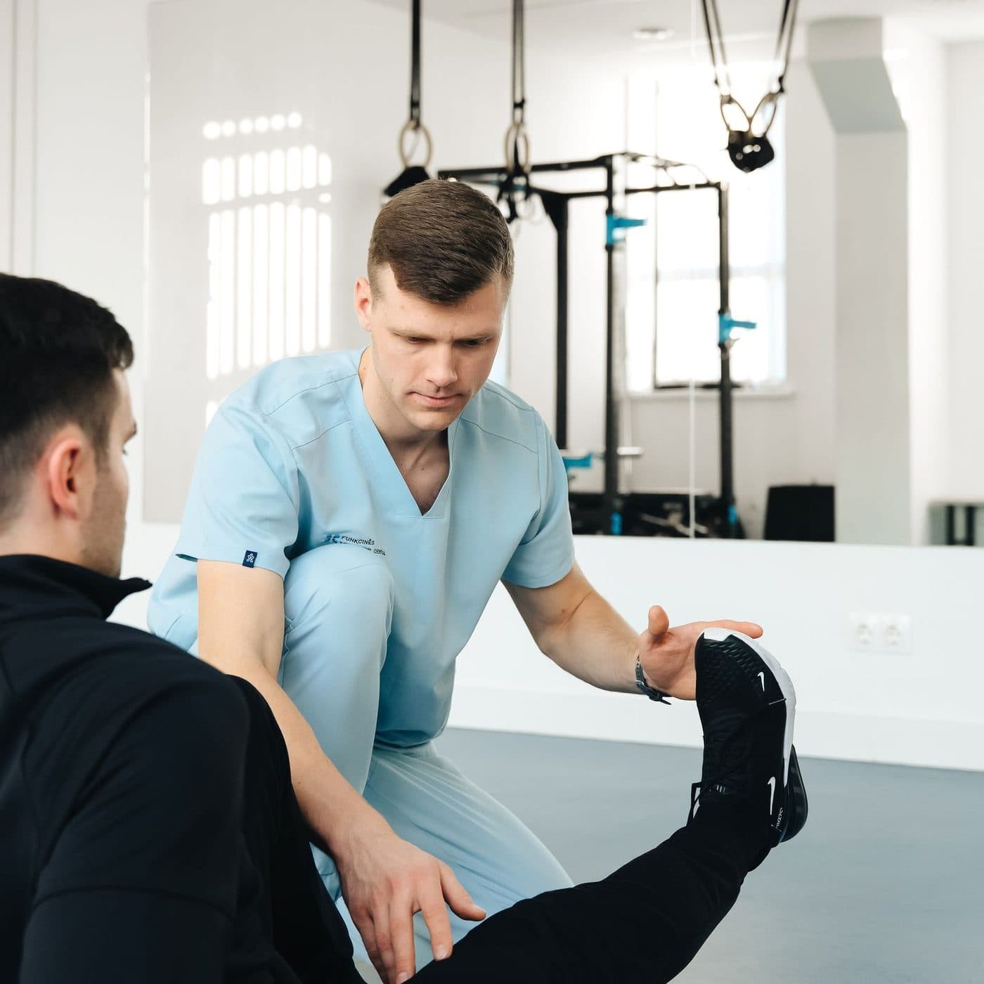 Physiotherapist demonstrating strength and conditioning work with a client